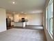 Open living area featuring hardwood floors, neutral carpet, and a kitchen with stainless steel appliances at 133 Bandimere Pkwy, Dallas, GA 30157