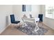 Bright office space with modern white desk, blue chairs, and large patterned area rug at 133 Bandimere Pkwy, Dallas, GA 30157