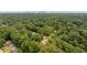 Aerial view showcasing lush greenery surrounding a neighborhood with downtown skyline in the background at 1355 Lockwood Sw Dr, Atlanta, GA 30311