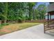 Fenced backyard with lawn surrounded by tall trees at 1355 Lockwood Sw Dr, Atlanta, GA 30311