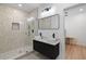 Modern bathroom featuring double sinks, a sleek shower with glass enclosure and contemporary fixtures at 1355 Lockwood Sw Dr, Atlanta, GA 30311