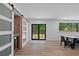 Bright dining room with sliding doors, a large window and a bar with sliding barn doors at 1355 Lockwood Sw Dr, Atlanta, GA 30311