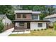 Modern two-story home with a covered front porch, clean lines and mixed materials at 1355 Lockwood Sw Dr, Atlanta, GA 30311
