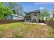 Backyard view of a modern two story home with a small balcony and wooden fence at 1355 Lockwood Sw Dr, Atlanta, GA 30311