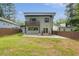 Backyard view of a modern two story home with a small balcony and wooden fence at 1355 Lockwood Sw Dr, Atlanta, GA 30311