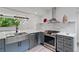 Stylish kitchen with a stainless steel sink, gray cabinets, modern countertops, and state-of-the-art appliances for culinary enthusiasts at 1355 Lockwood Sw Dr, Atlanta, GA 30311