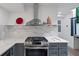 Contemporary kitchen featuring a stainless steel stove and range hood, sleek countertops, and modern gray cabinetry at 1355 Lockwood Sw Dr, Atlanta, GA 30311