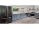 Modern kitchen with gray cabinets, stainless steel appliances, and a large black refrigerator at 1355 Lockwood Sw Dr, Atlanta, GA 30311
