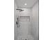 Modern shower featuring a rainfall showerhead, sleek fixtures, and elegant stone tile work at 1355 Lockwood Sw Dr, Atlanta, GA 30311