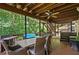 Outdoor living space featuring a covered wood deck, dining table, chairs and outdoor seating at 5130 Stoneywood Se Cir, Mableton, GA 30126