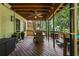 Outdoor living space featuring a wood deck, dining table, chairs and a ceiling fan at 5130 Stoneywood Se Cir, Mableton, GA 30126