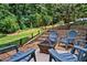 Backyard features a fire pit with chairs and a stairway leading to the house and yard at 5130 Stoneywood Se Cir, Mableton, GA 30126