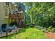 Backyard features an outdoor seating area, deck with steps to a patio with a hot tub at 5130 Stoneywood Se Cir, Mableton, GA 30126