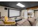 Home theater in a finished basement featuring a large screen and sectional sofa at 5130 Stoneywood Se Cir, Mableton, GA 30126