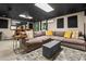 Finished basement with a large sectional sofa, custom rug, and a drop ceiling at 5130 Stoneywood Se Cir, Mableton, GA 30126