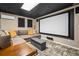 Entertainment space in the finished basement featuring a projector and comfortable sectional sofa at 5130 Stoneywood Se Cir, Mableton, GA 30126
