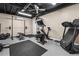 Spacious home gym in basement with stationary bike, treadmill, weight rack, and ceiling fan at 5130 Stoneywood Se Cir, Mableton, GA 30126