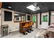 Basement bar area with dark wood bar, barstools, a mirror, and a beverage cooler at 5130 Stoneywood Se Cir, Mableton, GA 30126