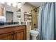 Cozy bathroom with vanity, granite countertop, and a tiled shower with shower curtain at 5130 Stoneywood Se Cir, Mableton, GA 30126