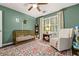 Bright Bedroom featuring a crib, a glider, a patterned rug, and great natural light at 5130 Stoneywood Se Cir, Mableton, GA 30126