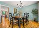 Elegant dining room with a wooden table, classic chairs, and a view to the kitchen at 5130 Stoneywood Se Cir, Mableton, GA 30126
