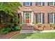 Close-up of a classic brick home's front door with decorative details and landscaping at 5130 Stoneywood Se Cir, Mableton, GA 30126