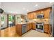 Well-appointed kitchen with stainless steel appliances, wooden cabinets, and a breakfast bar at 5130 Stoneywood Se Cir, Mableton, GA 30126
