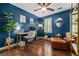 Home office featuring hardwood floors, a modern desk, a chair, and a comfortable leather couch at 5130 Stoneywood Se Cir, Mableton, GA 30126