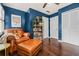 Home office with hardwood floors, built-in bookshelves, and a comfortable leather chair and ottoman at 5130 Stoneywood Se Cir, Mableton, GA 30126
