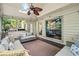 Relaxing sunroom with plentiful seating, large windows, and a ceiling fan for ultimate comfort at 5130 Stoneywood Se Cir, Mableton, GA 30126