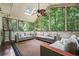 Cozy sunroom is enclosed in windows to provide a relaxing, light-filled space with forest views at 5130 Stoneywood Se Cir, Mableton, GA 30126
