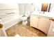 A bathroom featuring a white vanity with a mirror, toilet, and a bathtub with white tile surround at 134 Odyssey Turn, Conyers, GA 30012