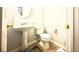 Powder room features a pedestal sink and toilet with tiled floors at 134 Odyssey Turn, Conyers, GA 30012