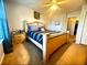 A bedroom with a queen-sized bed with ornate wood frame, side tables, ceiling fan and view to the outside at 134 Odyssey Turn, Conyers, GA 30012