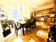 Dining area leading to kitchen with dark cabinets and modern appliances at 134 Odyssey Turn, Conyers, GA 30012