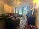 Spacious living room features a large sectional sofa and a large window at 134 Odyssey Turn, Conyers, GA 30012