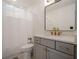 Bathroom with a grey vanity with a sink, gold fixtures, and a shower with white curtains at 86 Whitlock Sw Sq, Marietta, GA 30064