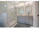 Bathroom with a glass shower, grey vanity with double sinks and gold fixtures at 86 Whitlock Sw Sq, Marietta, GA 30064