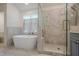 Bathroom featuring a modern soaking tub, walk-in shower, and herringbone tile at 86 Whitlock Sw Sq, Marietta, GA 30064