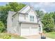Charming two-story home with white brick and siding, attached two-car garage, and well-maintained landscaping at 86 Whitlock Sw Sq, Marietta, GA 30064