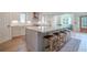 Open kitchen boasts an oversized island with seating, quartz counters, and stainless steel appliances at 86 Whitlock Sw Sq, Marietta, GA 30064