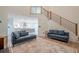 Open-concept living room with modern staircase, light hardwood floors and plenty of natural light at 86 Whitlock Sw Sq, Marietta, GA 30064