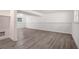 Finished basement with wood-look flooring, brick accent wall, and natural light at 3195 Newcastle Way, Snellville, GA 30039