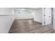 Spacious basement featuring wood-look flooring, white brick accent wall, and natural light from above-ground windows at 3195 Newcastle Way, Snellville, GA 30039