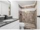 Renovated bathroom showcasing a tiled walk-in shower, modern fixtures, and granite vanity at 3195 Newcastle Way, Snellville, GA 30039