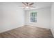 Bright bedroom featuring a ceiling fan, hardwood floors, and large window offering natural light at 3195 Newcastle Way, Snellville, GA 30039
