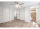 Neutral bedroom with hardwood floors, ceiling fan, and a glimpse into the bathroom at 3195 Newcastle Way, Snellville, GA 30039