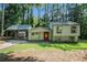 Charming home featuring a covered carport, a red front door, and a lush front yard at 3195 Newcastle Way, Snellville, GA 30039