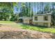 Charming home featuring a covered carport, a red front door, and a lush front yard at 3195 Newcastle Way, Snellville, GA 30039