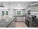Modern kitchen with granite countertops, stainless steel appliances, and double doors to the deck at 3195 Newcastle Way, Snellville, GA 30039